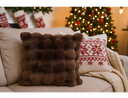 Chocolate brown cushion with faux fur fabric on a sofa 