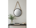 A round mirror with black frame and a rope 